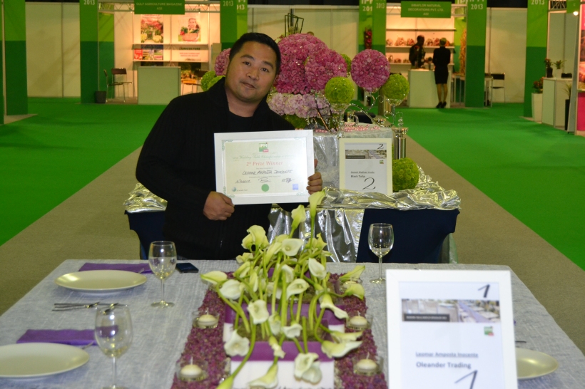 Leomar A. Inocente, Head Florist of Oleander Trading Dubai, holds his certificate as 2nd prize of Wedding Table Championship #